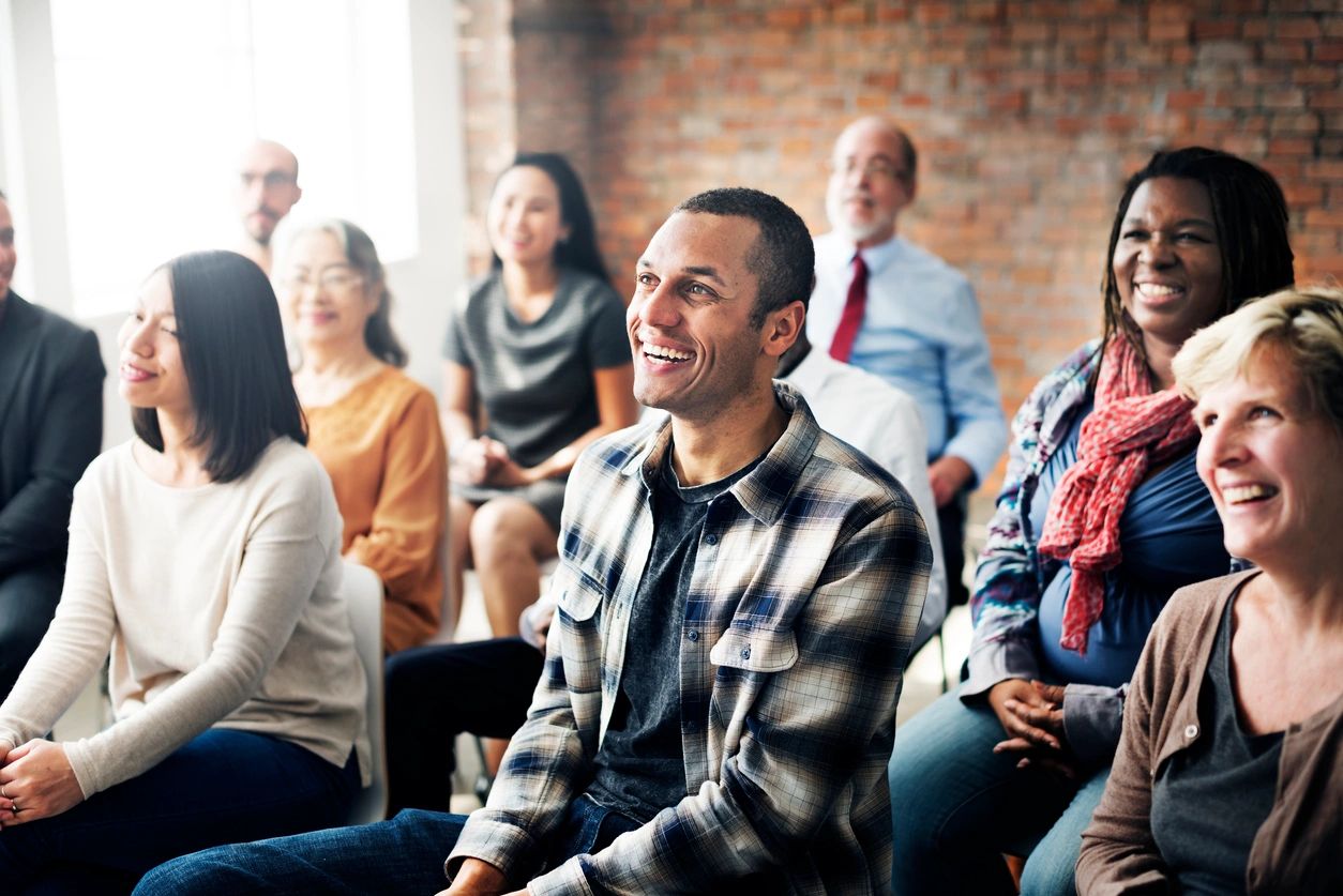 Adults learning together in a room with bright lights.