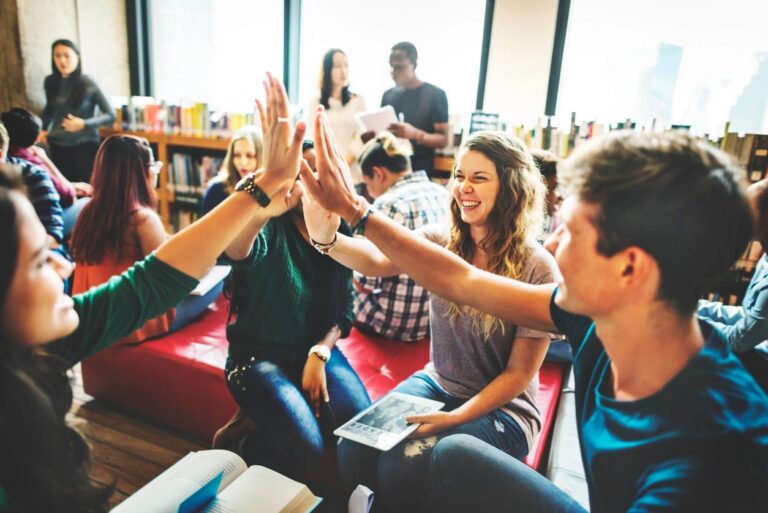 Educators giving one another a high five